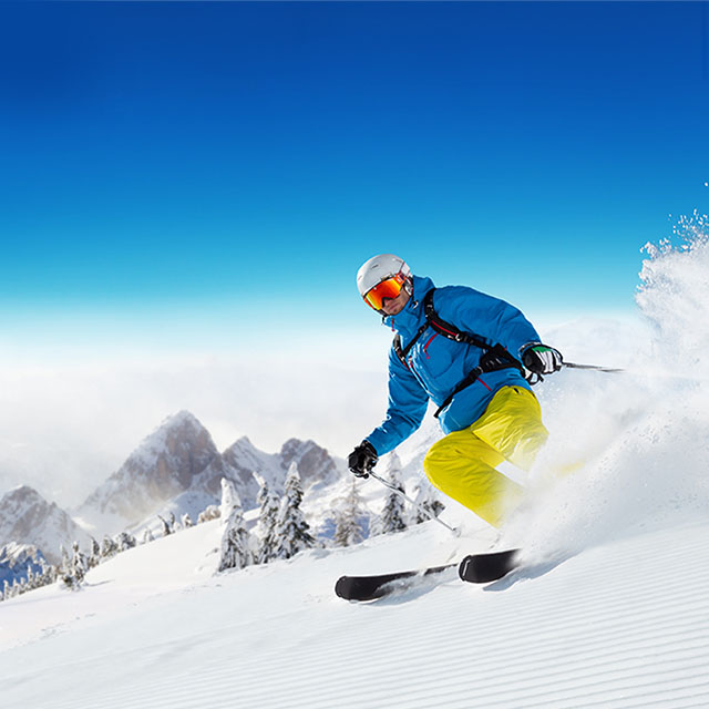 A person on skis going down a slope