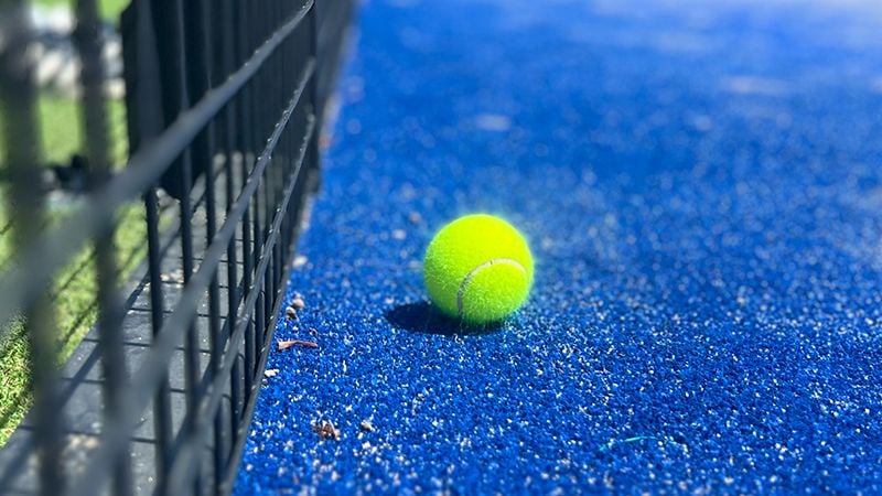 A squash ball on the blue court